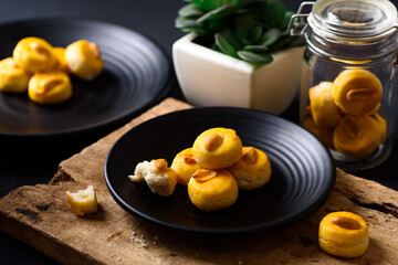 Asian peanut cookies on black plate