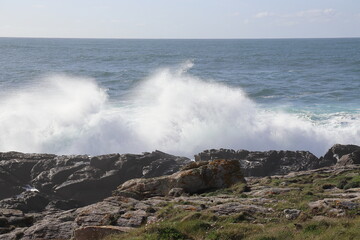 Sea waves crashing against rocks.