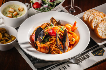 Seafood pasta with bread, soup and salad