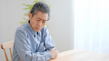 悩む高齢の男性