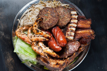 Asian food platter.  Grilled shrimp, beef patties, octopus, and pork belly.