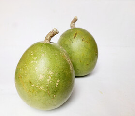Aegle Marmelos is indian subcontinent fruit for medical use ion white background with pulp .
