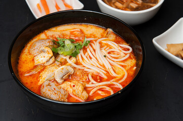 Beef in black bean sauce with flat rice noodles at a Korean restaurant.