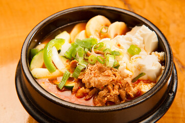 Kimchi, tofu, and pork hotpot at a Korean restaurant.