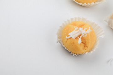 Toddy Palm Cake with coconut (Kanom Tarn) made from rice flour, palm oil, sugar and salt on white background, Thai dessert sweet taste delicious.