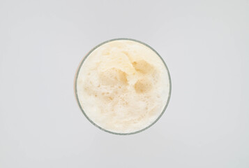 Glass of beer with foam, top view.