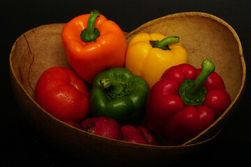 vegetables in basket in black background
