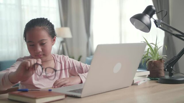 Stressed Asia Teen Girl Suffer From Headache Bad Vision Sight Problem Sit At Home Table
