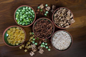 plano cenital de cuencos con frutos secos sobre fondo de madera