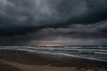 Dramatic dark storm clouds over the ocean after the sunset