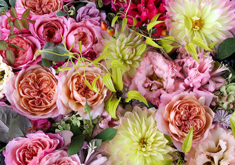 Flower arrangement of English roses, lisianthus, and dahlias.