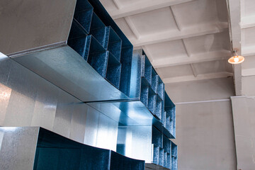 square air ducts neatly stacked in a ventilation system, foreground and background blurred with bokeh effect