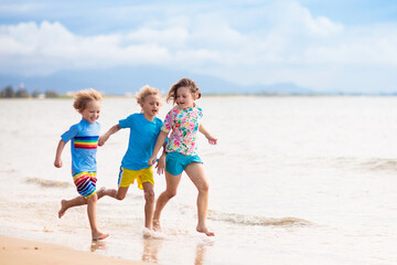 Kids playing on beach. Children play at sea.