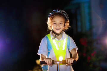 Safety on dark street. Kids reflective vest. - obrazy, fototapety, plakaty