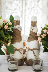 decorated champagne bottles, glasses and flowers. wedding theme