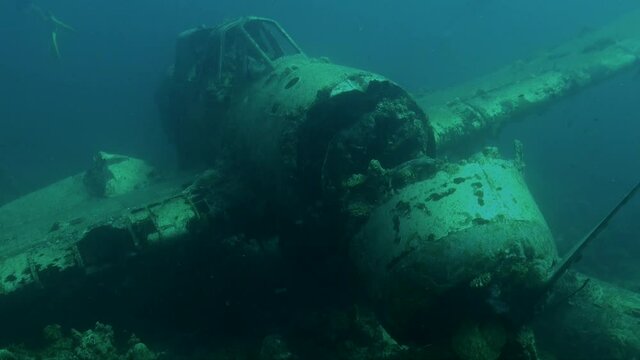 Airplane wreck underwater lying on ocean floor in Palau Island Micronesia