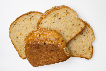 Four slices of whole-grain bread with vegetables, flax seeds and sesame. A healthy vegetarian meal. Isolated flatlay.