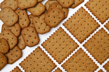 Pattern of wholegrain spicy crackers. Isolated on a white background.