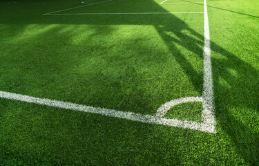 green artificial grass football or soccer field with white line background.