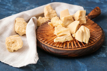Board with cocoa butter on color background, closeup