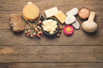 Spa set with shea butter on wooden background