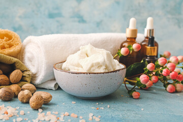 Composition with shea butter, nuts and bath supplies on color background