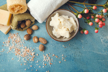 Composition with shea butter, nuts and bath supplies on color background