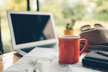 coffee cup and other travel accessories around on the table. Vocation, travel, holidays and backpack concept.