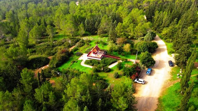 Aerial Panning Shot Of Pagoda In Forest On Sunny Day, Drone Flying Over Trees - Ben Shemen, Israel