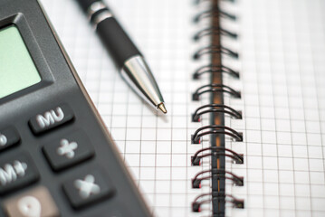 Calculator and pen on notebook. Business plan analysis concept. Business concept.Closeup.