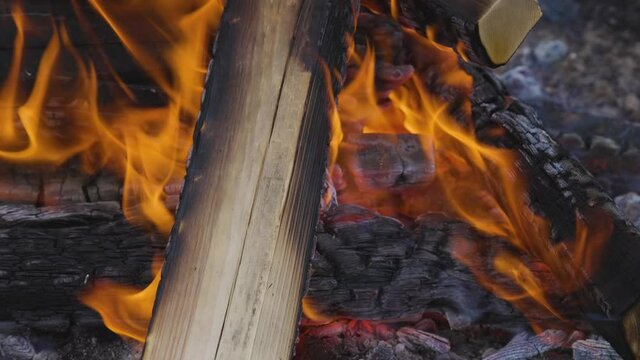 Close up picture of wood burning in a camp fire. Hot Red Flames. Taken in British Columbia, Canada. Slow Motion