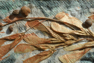 Composition of glued dried maple leaves on a colored paper background. Flat lay, top view