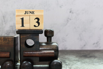 Fototapeta na wymiar Day 13 of June month. Wooden calendar with date. Empty space for text.