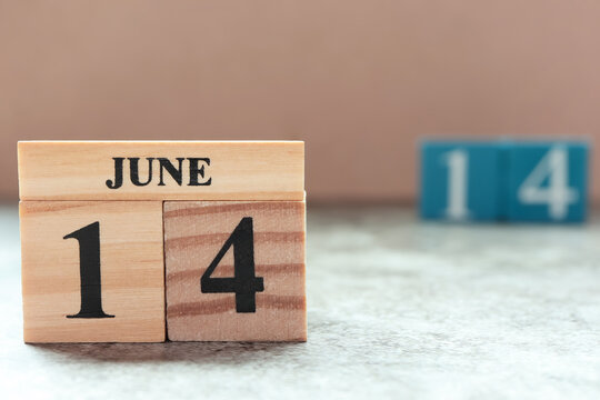 Day 14 of June month. Wooden calendar with date. Empty space for text.