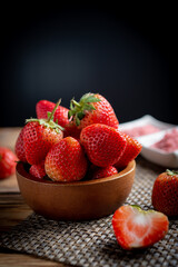 Fresh strawberries in wooden bowl.