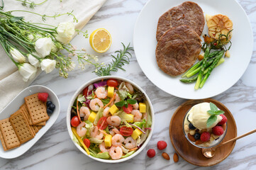 Steaks, salads, desserts and other delicacies on the table