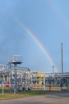 Rainbow is upon gas plant, summer day