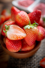 Fresh strawberries in wooden bowl.