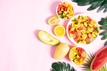 Chopped tropical fruit in bowls and plates