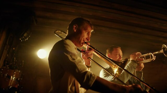 HANHDHELD CU Portrait Of Jazz Band Members Playing Brass Instruments On Stage During A Live Concert In Small Venue. Shot On ARRI Alexa Mini With 2x Anamorphic Lens