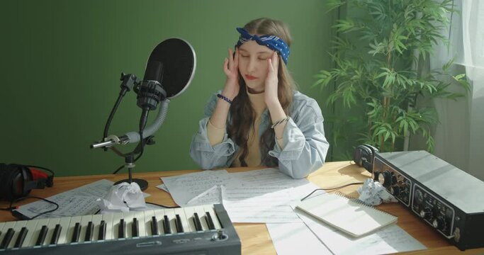 Upset songwriter crumpling and throwing paper away