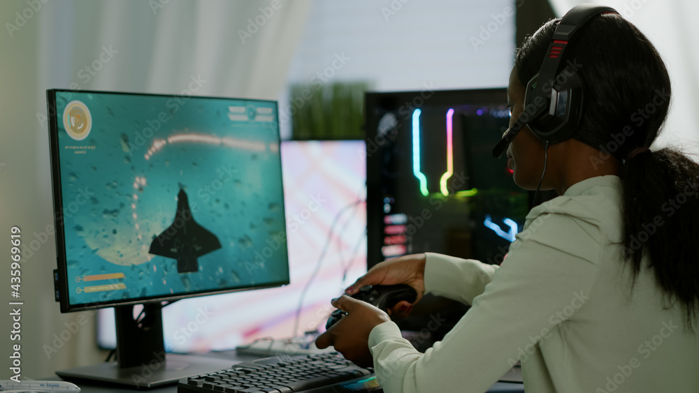 Poster pro african gamer playing online space shooter game on powerful computer using wireless controller a