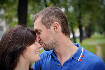 The guy kisses his girlfriend's nose. - 435970016