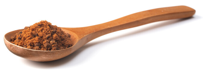 brown sugar in the wooden spoon, isolated on white background