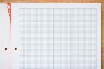 School graph paper notebook, real paper on desk