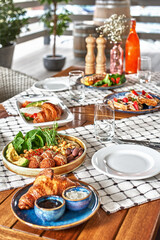 traditional breakfast with croissants and coffee served on wooden table. French breakfast.