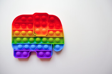 Colorful pop it toy on a white background. Bright interesting brainstorm. Empty space for your text or design.