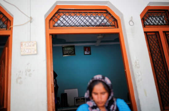 Uman Bhati, 27, daughter-in law of Balraj Singh, a teacher who died from the coronavirus disease (COVID-19) after he attended his local election duty in April, sits inside her house at Astoli village