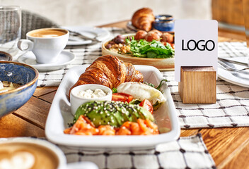 table on the terrace with breakfast and coffee on a wooden table, blank sticker with copy space.