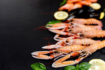 Norway Lobster or langoustineon a dark rustic background. Nephrops norvegicus, Dublin Bay prawn, langostino or scampi close up